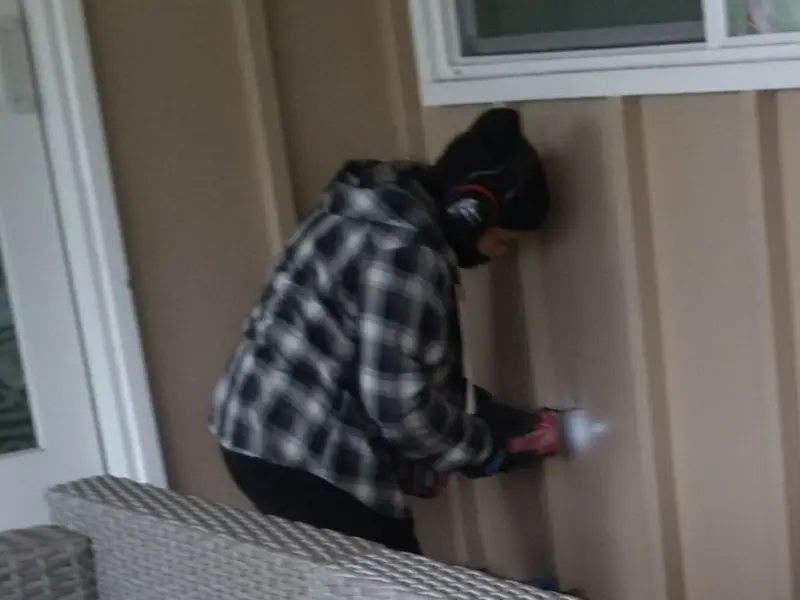 Professional electrician installing an exterior outlet in Penn